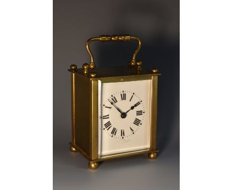 An early 20th century French lacquered brass carriage timepiece, 5.5cm rectangular enamel dial inscribed with Roman numerals,