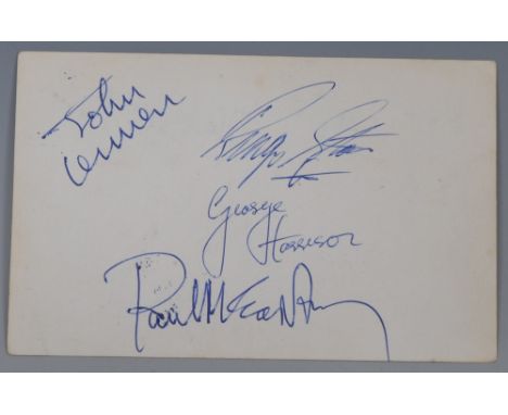  The Beatles, b/w band postcard, the verso signed in blue biro with John Lennon, Paul McCartney, Ringo Starr and George Harri