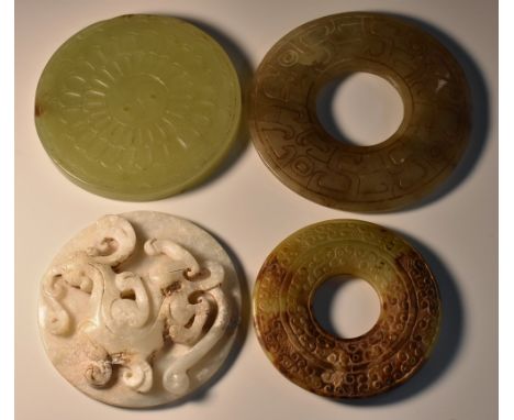 A Chinese jade circular disc, the centre carved with yin and yang with radiating flutes, 7.5cm diam;  others (4)