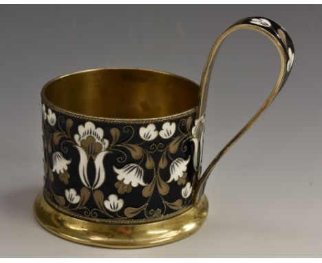 A Russian silver-gilt and cloisonne enamel tea glass holder, decorated with stylised flowers on a noir ground, scroll handle,