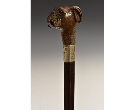 A Victorian silver-mounted softwood and malacca walking stick, the pommel carved as a boxer dog, with inset glass eyes, the s