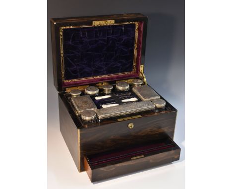 An early Victorian brass mounted coromandel rectangular dressing box, hinged cover enclosing a lift-out tray, necessaire impl