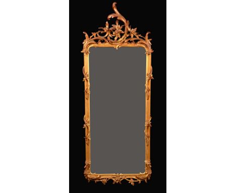 A late 19th century Chippendale Revival giltwood and gesso shaped rectangular looking-glass, bevelled mirror, C-scroll, rocai