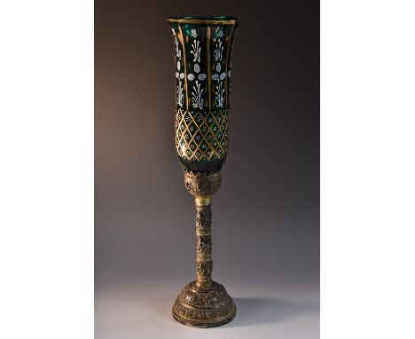 An early 19th century Indian silvered brass candlestick, acanthus capped sconce cast with a border of seated deities in lotus