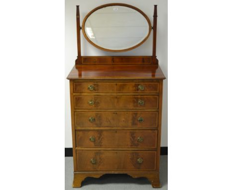An Edwardian mahogany dressing chest, oval mirror, moulded oversailing top, five graduated drawers, spreading bracket feet, k