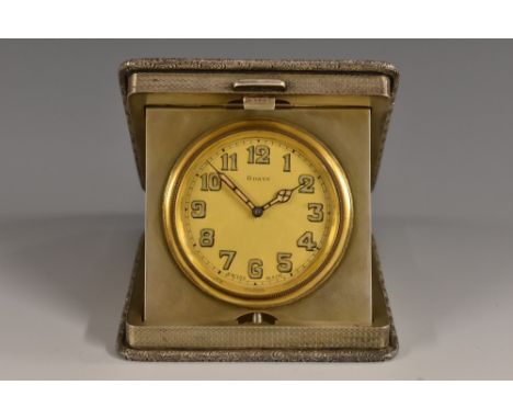 A George V silver rounded square travelling timepiece, 4.5cm gilt dial with Arabic numerals, eight-day keyless movement, the 