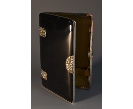 An Art Deco silver and noir enamel rounded rectangular cigarette case, hinged cover paste set in geometric motifs, gilt inter