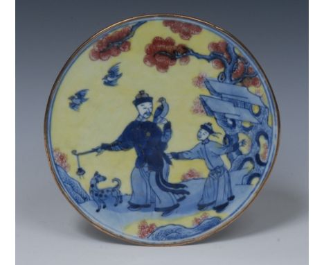 A Chinese gilt-metal mounted porcelain circular fragment, painted in underglaze blue with a mandarin holding an opium pipe wi