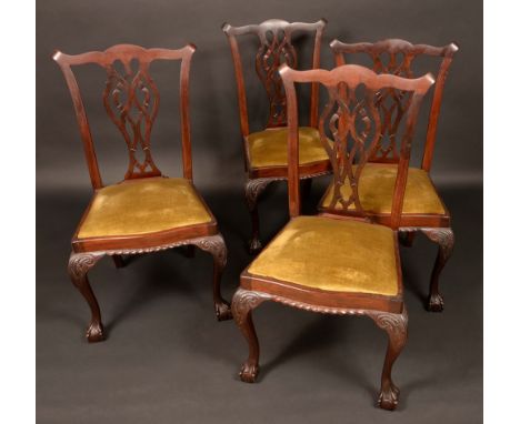 A set of four Chippendale Revival mahogany dining chairs, Cupid's bow cresting rails, shaped and pierced splats, drop-in seat