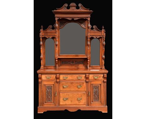 A Victorian walnut sideboard, swan neck pediment above an arched bevelled mirror and a rectangular shelf, flanked by further 