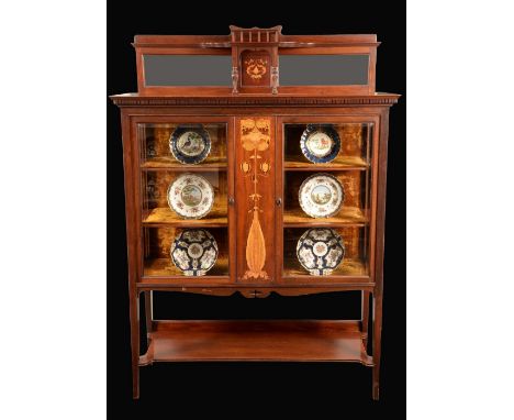 An Art Nouveau mahogany and marquetry salon cabinet, shaped cresting above a superstructure centred by a projecting three-qua