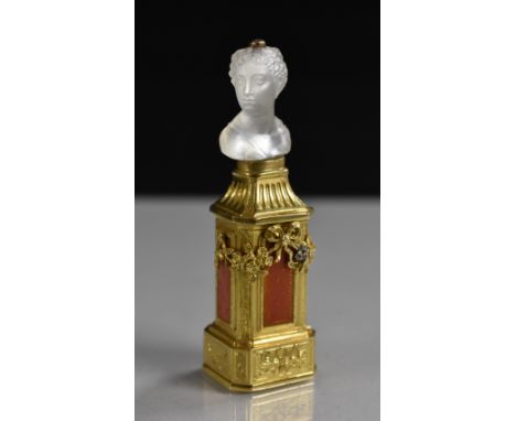 A 19th century rock crystal mounted seal/bonbonnière, carved as a classical maiden, the base applied in relief with bell husk