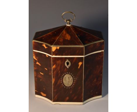 A George III tortoiseshell tea caddy, of rectangular form, with re-entrant angles, outlined with silvered coloured metal stri