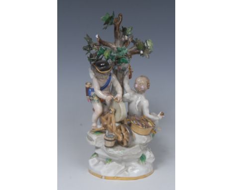 A Meissen figure group, modelled with Cupid sharpening his arrows on a wheel, a seated scantily-draped putto holding an arrow