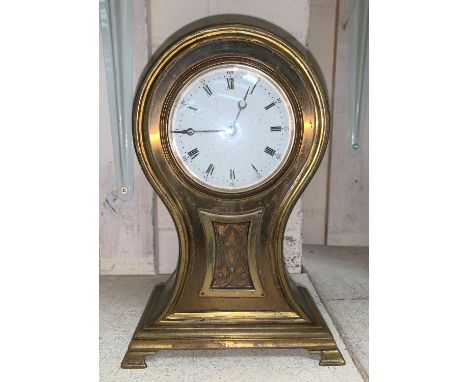 An Edwardian brass mantel clock with balloon top, white enamel dial and French balance spring movement 
