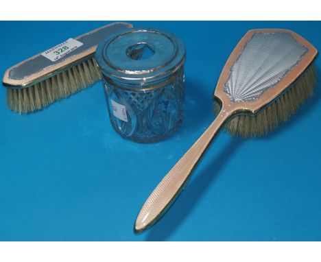 A silver gilt and enamel hairbrush and matching clothes brush; a hairpin tray with silver top 