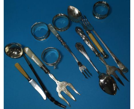 Four silver napkin rings; a toddy ladle (unmarked); items of cutlery 