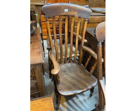 A 19th century elm lath back armchair; a similar ladder back armchair 