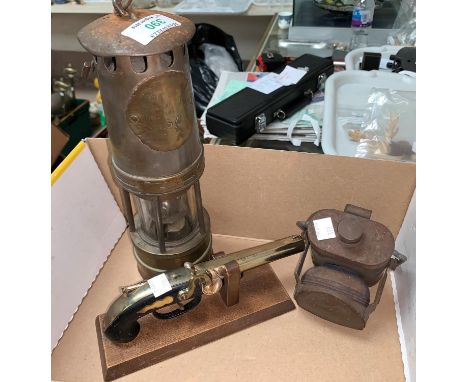 An early 20th century brass miner's lamp with steel bonnet, 'Woods Improved Lamp'; a vintage signal / bicycle lamp; a replica