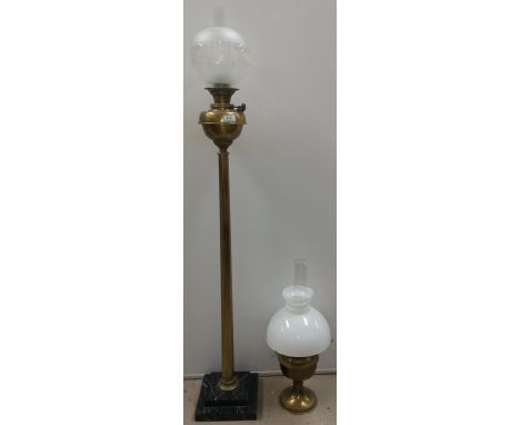 A brass hexagonal standard oil lamp on marble base with brass reservoir, glass shade and chimney; a brass table lamp and shad