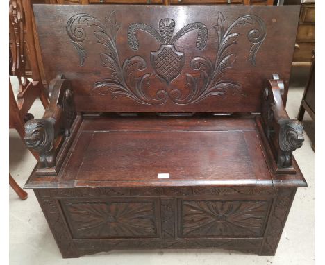 An early 20th century carved oak monks bench 