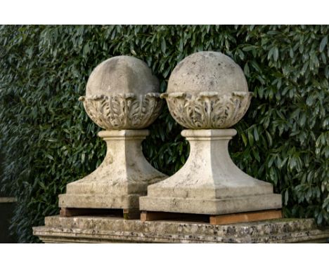 Architectural: † A pair of Edwardian substantial carved Portland stone gate pier balls on bases  circa 1900 104cm high, bases