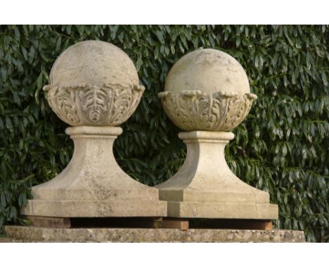 Architectural: † A similar pair of carved Portland stone gate pier balls on bases  104cm high, bases 66cm square