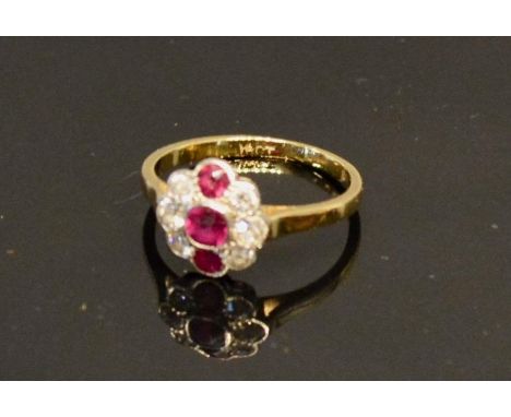 An 18 Carat Gold Ruby and Diamond Cluster Ring 