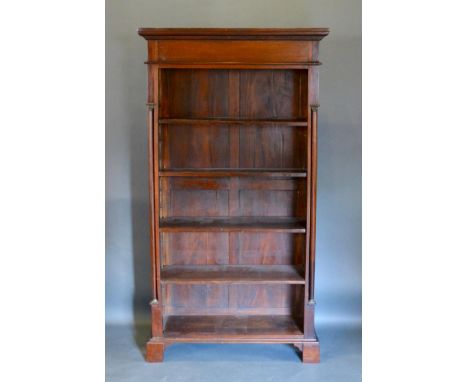A 20th Century Hardwood Bookcase, the moulded cornice above open shelves flanked by turned pilasters raised upon bracket feet
