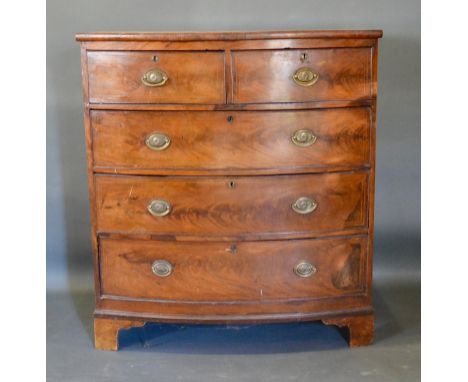 A 19th Century Mahogany Bow-Fronted Chest of Two Short and Three Long Drawers with oval brass handles raised upon bracket fee