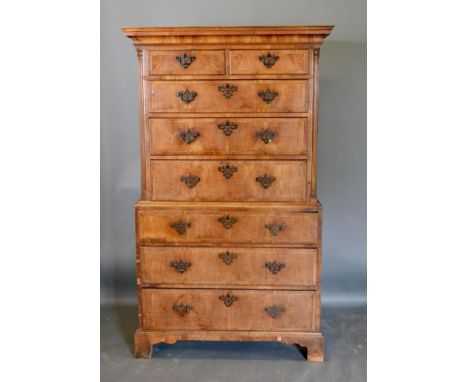 A George III Walnut Chest on Chest, the upper section with moulded cornice above two short and three long graduated and cross