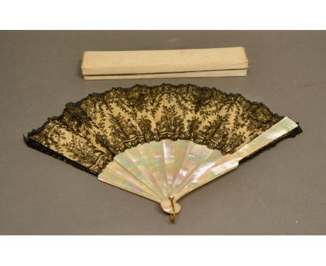 A 19th Century Chantilly Black Lace Fan with mother of pearl sticks and guards, rivets set with stones, within original box, 