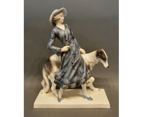 A Goldscheider Porcelain Group in the form of a girl with dog, 31cm tall 