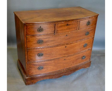 A 19th Century Mahogany Bow-Fronted Chest of Drawers, the moulded top above three small and three long drawers with oval bras