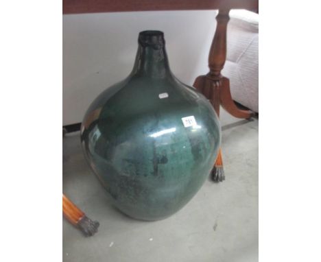 A large vintage green carboy bottle Height 62cm approx, top is not smooth, but it is the way it was made