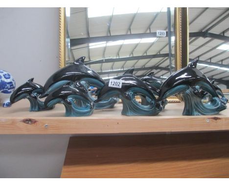 7 Poole pottery dolphins, 2 large (H 17.5cm) 1 medium (H 14.5cm) and 4 small (H 10.5cm) (1 small one has a chip on hole in ba