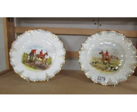 A pair of Royal Crown derby plates hand painted with hunting scenes.