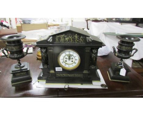 A 3 piece Edwardian black slate clock garniture with side urns, Benetfink &amp; Co., London, Made in Paris.