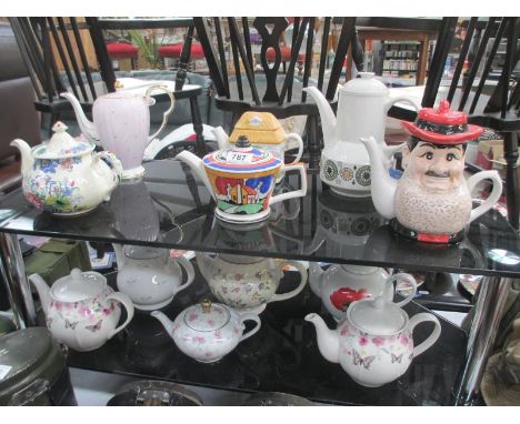 12 collectors teapots including Masons, Broadhurst, Kathie Winkle etc. Desperate Dan has tiny chip