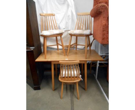 An oak effect draw leaf table and 4 stick back chairs 120cm x 60cm x height 74cm extended