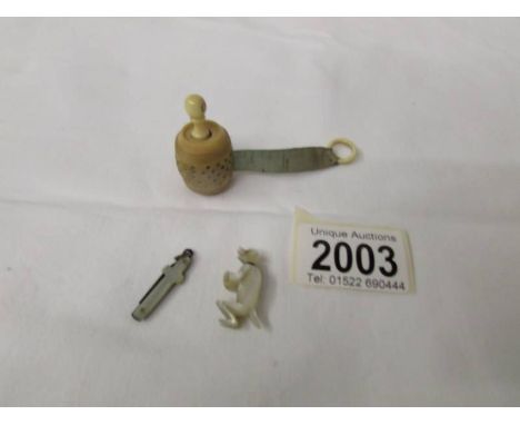 A miniature mother of pearl penknife in the shape of a cross, A vintage tape measure in the shape of a barrel and a miniature