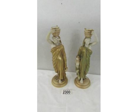 A pair of Royal Worcester candle sticks in the form of Grecian ladies, 1 a/f (chip to handle of urn). ****Condition report***