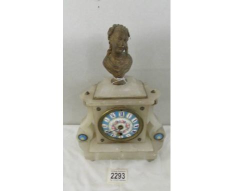 An alabaster mantel clock with enamel dial.