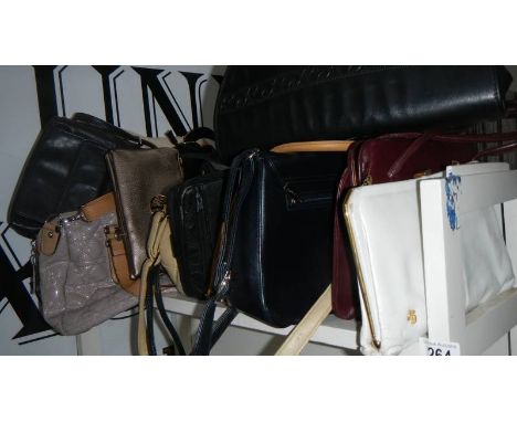 A shelf of assorted handbags.