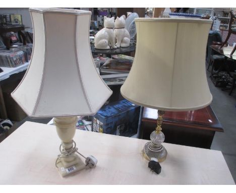 A brass and glass table lamp with shade and 1 other