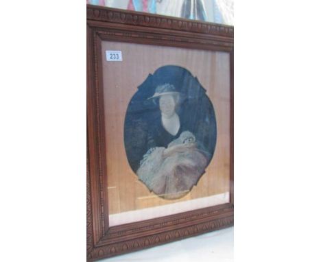 A framed and glazed portrait of a lady.