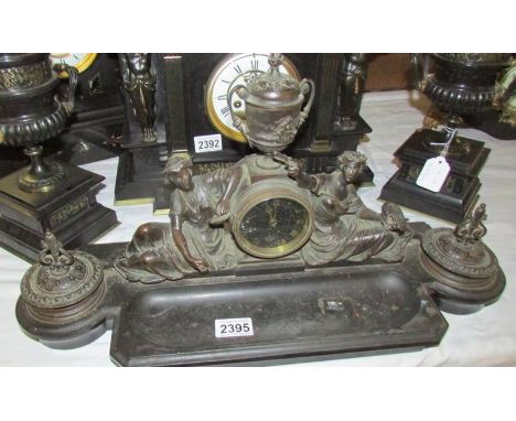 A superb quality desk stand with clock surmounted by figures, 2 inkwells (missing liners) and a pen tray.