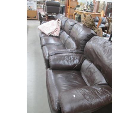 A dark brown 3 piece suite in leather with pouffe