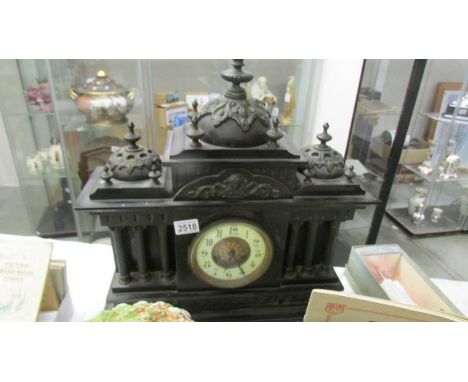 A 19th century black Palladian style mantle clock (chimes a/f).