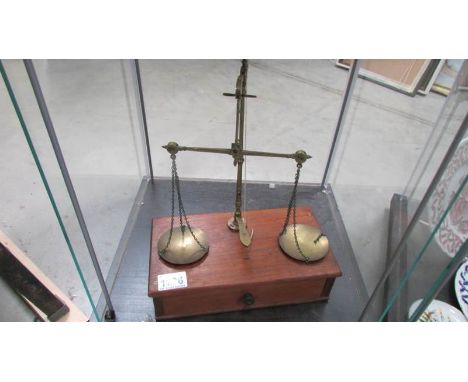 A set of Victorian/Edwardian brass postal scales with weights.